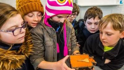 Children looking at historic artefact