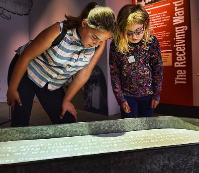 children looking at museum collection